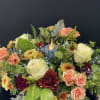 This floral arrangement comes in a beautiful ceramic bowl with leaves and