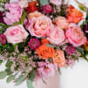 This sweet mix of seasonal florals in hues of pinks, oranges with
