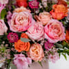 This sweet mix of seasonal florals in hues of pinks, oranges with