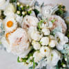 Modern white marble vase filled with white Ohara Garden Roses, Lisianthus, Eucalyptus