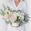 Modern white marble vase filled with white Ohara Garden Roses, Lisianthus, Eucalyptus