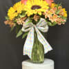 Bursting with cheer, this radiant arrangement combines golden sunflower, orange roses, and
