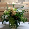 Just Elegance describes this beautiful arrangement of greens, peach and white flowers.