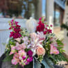 Beautiful statue of an Angel with surrounding seasonal flowers. Some flowers may