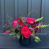 Luxurious tones of reds and pinks fill a timeless black ceramic vessel.

Standard