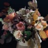 Stunning vessel filled with orchids, garden style roses, fall color greenery, callas