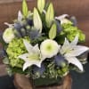 This timeless bouquet includes fragrant lilies, lush hydrangeas and blue thistles. Artfully