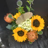 Sunflowers, protea, and thistle is the composition of color perfect for any