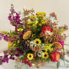 A radiant celebration of autumn&#039;s bounty, this arrangement is overflowing with warmth