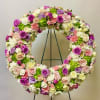 This Standing Wreath Includes White roses, Light Pink Roses, Lavender Roses, Green