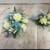 1] white roses wrist corsage with light blue ribbon
1] boutonniere to match