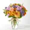 Soft lavender and peach stems are expertly arranged with deeper shades to