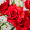 This stunning floral arrangement showcases an artful blend of graceful forms and