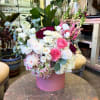 A lush, romantic arrangement designed in our signature pink hatbox. Filled with