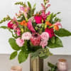 Bright sunflowers, golden roses, and soft white blooms are gathered with fresh