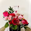 Exquisitely crafted with premium hot pink roses, premium accents and seasonal greens