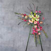 This elegant standing sympathy arrangement features a graceful blend of soft and