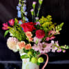 Dahlia, Delphinium, Lisianthus,  Roses with fillers in a dainty painted pitcher.