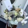This delightful arrangement features soft blue hues, fresh white blooms, and cheerful