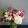 A beautiful one-of-a-kind arrangement made with fresh seasonal flowers.