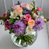 Lavender shades paired with light spray roses and dahlias create a harmonious