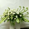 This Casket Spray Includes Bells of Ireland, White Roses, White Dendrobium Orchids