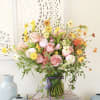 This exquisite bouquet features delicate coral peachy garden rose, ranunculus, hydrangea with