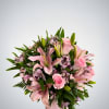 This charming arrangement features soft pink roses, elegant pink lilies, and delicate