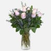 soft pink roses in a vase with eucalyptus