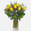 Dozen yellow roses in a vase with eucalyptus
