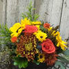 An oven safe baking dish comes packed with fall goodies....sunflowers, roses,mums and