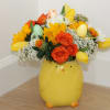 This Easter bouquet combines a variety of flowers in vibrant colors, whimsical