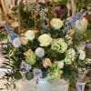 A large statement arrangement featuring fresh blooms in soft colors. Perfect to