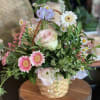 Seasonal pastel flowers in a woven basket. Perfect for gifting.