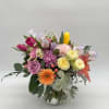 Soft pastels and cheerful blooms come together in this whimsical spring arrangement