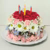 A fresh and beautiful fresh flower cake of assorted flowers and candles.