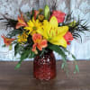 A crisp autumn mix of daisies, lilies, roses, and alstroemeria with added