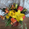 A crisp autumn mix of daisies, lilies, roses, and alstroemeria with added