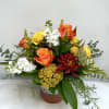 Full of autumn colors, this design features roses, yarrow, stock and more.