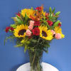 A gorgeous bouquet handcrafted and designed in a beautiful clear glass vase.