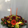 This stunning mix of fresh Autumn blooms, greenery and two candles makes
