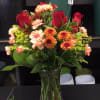 This stunning bouquet features red roses and a mix of fresh Autumn