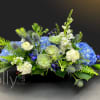 Composed of blue hydrangeas, succulents, and thistle.