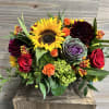 A fuller bouquet of fall favorites of sunflowers, kale, spray roses, dahlias