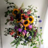 A vibrant spray of colorful blooms, honoring a life lived with joy
