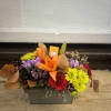 A fresh fall arrangement in a low tin vase. 