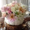 A very unique floral design in a REAL white pumpkin is created
