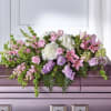 Composed of refined lavender and pink blooms, our Casket Spray beautifully honors