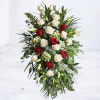 The Eternal Tribute Standing Spray is a graceful expression of remembrance, featuring