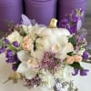 White ceramic pumpkin vase with fresh flowers. 
